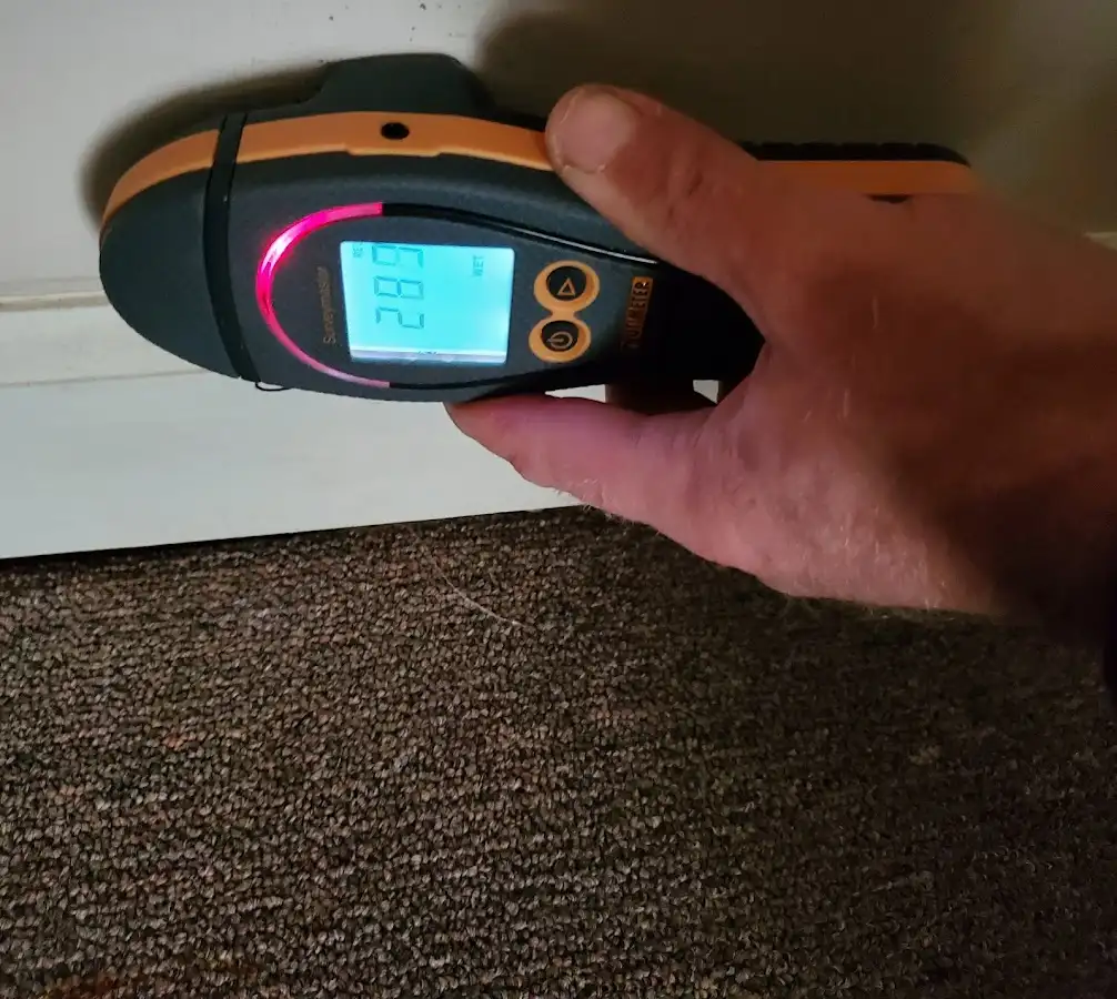 Moisture detection at baseboard during Storm Damage Restoration in Whitewater